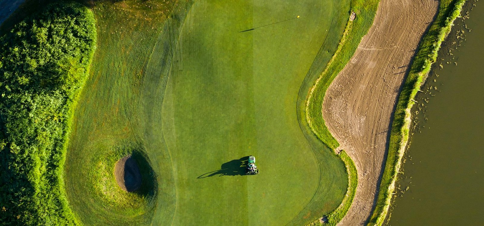 Golfer lining up a putt on a manicured green during a club tournament
