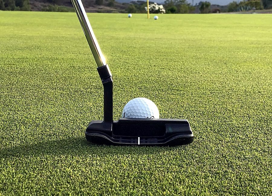 Two golfers greeting each other on the tee box before starting their round