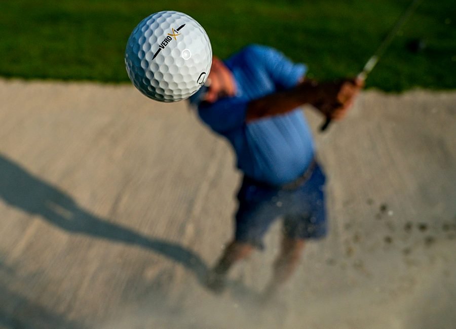 Golfer stretching on the practice tee during a pre-round warm-up