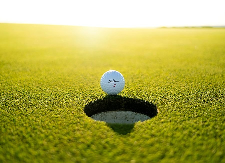 Golfers walking the fairway together on a sunny morning