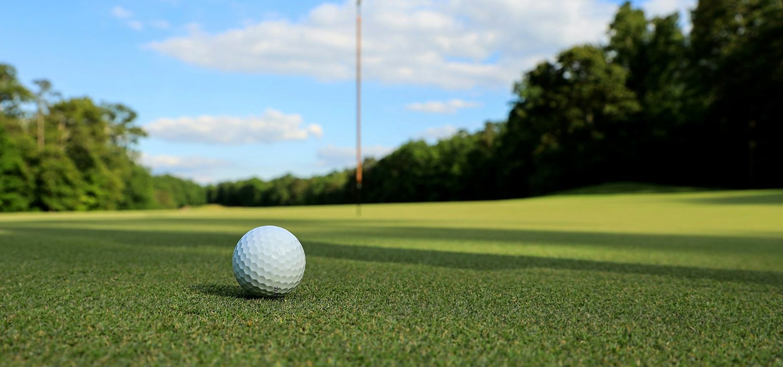 A group of friends laughing together on the fairway after a round of golf